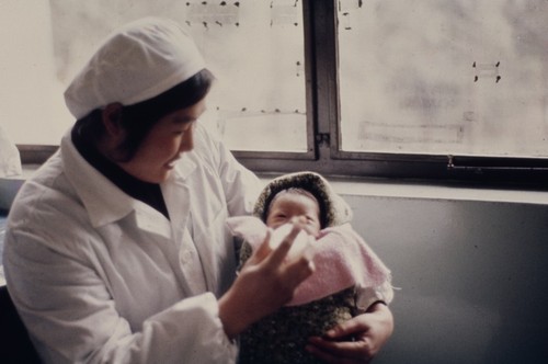 Luda Shi No. 2 People's Hospital, medical worker taking care of infant