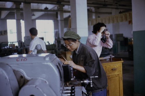 Factory worker operating machinery