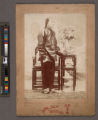 Portrait of a Chinese woman standing next to table and chair