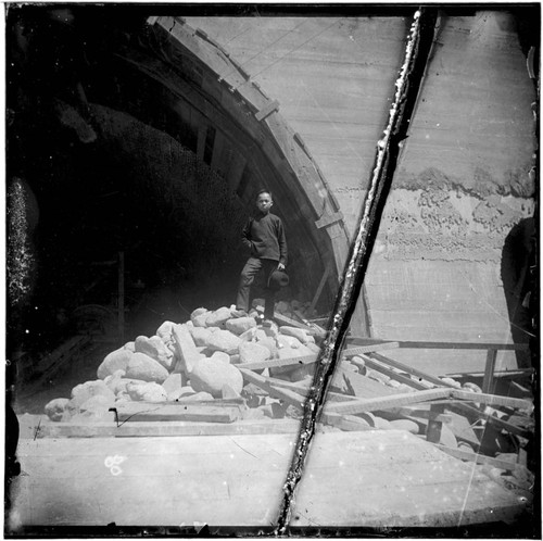 Boy standing on pile of rubble