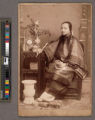 Portrait of a Chinese woman, seated, holding objects