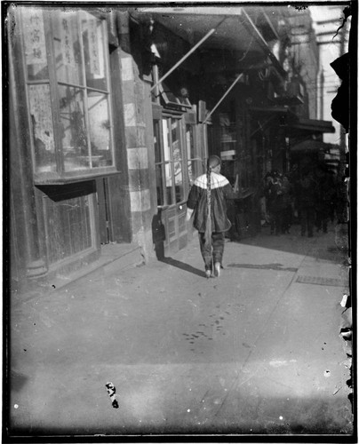 Person with long ponytail walking down street