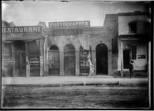 Exterior of photographer's studio, with signs in English and Chinese