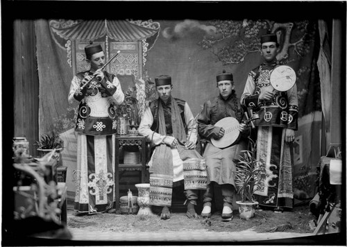 Portrait of four men with musical instruments, alternate pose