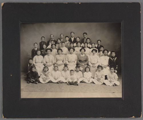 Chin Quan Gue and Mabel Chin in a group photograph