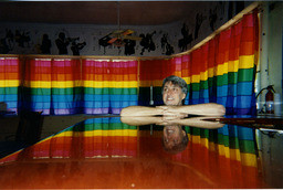 Gilbert Baker with rainbow curtain