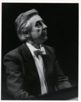 Walter Klien playing the piano in concert attire, 1986 [descriptive]