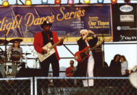 Bo Diddley and an unidentified guitarist and drummer performing at the Santa Monica Pier Twilight Dance Series, July 9, 1998 [descriptive]