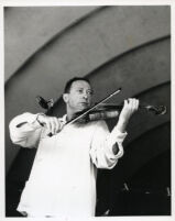 Jascha Heifetz playing the violin, 1957 [descriptive]