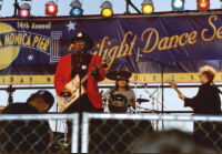 Bo Diddley and an unidentified guitarist and drummer performing at the Santa Monica Pier Twilight Dance Series, July 9, 1998 [descriptive]