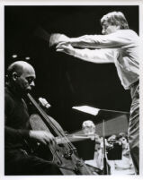 Janos Starker playing the cello in rehersal with an orchestra, 1986 [descriptive]