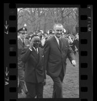 President Lyndon B. Johnson and Upper Voltian President Maurice Yaméogo with arm raised, 1965 [7]