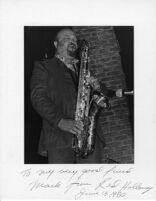 Autographed photo of Red Holloway playing saxophone, 1977 [descriptive]