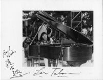 Autographed photograph of Toshiko Akiyoshi and Lew Tabackin at Barnsdall Art Park in Los Angeles, 1977 [descriptive]