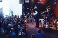 Tom Guralnick playing saxophone for school kids, 1997 [descriptive]