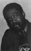 Sherman Ferguson smoking a pipe, 1983 [descriptive]