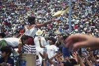 Chines de Oaxaca, performers throwing gifts to spectators, 1982