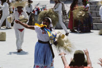 Tlaxiaco, performers throwing gifts to spectators, 1982 or 1985