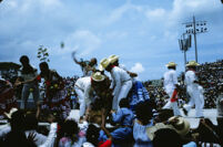 Chines de Oaxaca, performers throwing gifts to spectators, 1982