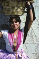 Chines de Oaxaca, woman holding flower basket on head, 1982