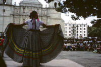 Awarding of prizes[?], woman displaying her skirt, 1985