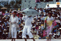 Tehuantepec, man carrying fake fish on shoulder, 1982 or 1985