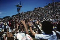 Tlaxiaco, performers throwing gifts to spectators, 1985