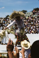 Tlaxiaco, performers throwing straw hats to spectators, 1982 or 1985