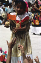 Tehuantepec, girl handing object to spectators, 1982 or 1985