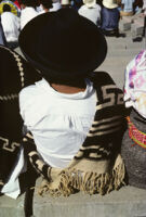 Guelaguetza[?], performers sitting with spectators [view from behind], 1982 or 1985