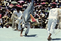 Tehuantepec, man carrying fake fish chased by nets, 1982 or 1985