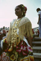 Awarding of prizes[?], woman wearing sash and gold necklace, 1985