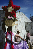 Chines de Oaxaca, woman holding flower basket on head, 1982