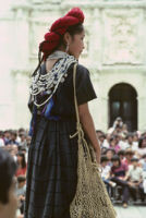 Awarding of prizes[?], woman holding netted bag, 1985