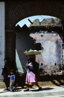 Oaxaca, woman walking with basket on head, 1982 or 1985