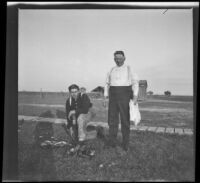 Guy Mansberger and Mat Everhardy cleaning ducks, Orange County vicinity, about 1912