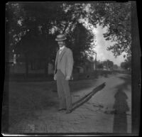 Independence (Inda) Stevens stands in the middle of a dirt road, Red Oak, 1900