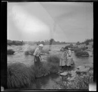 William "Babe" Bystle and Frances and Elizabeth West stand in the Sacramento River, Redding vicinity, about 1914