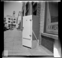 Woodlin electric refridgerator, viewed at an angle on a sidewalk, Los Angeles, 1948