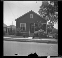 Wilson D. West poses in front of the old West family residence on South Workman Street, Los Angeles, 1936