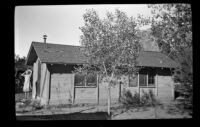 Mertie West on the porch of a cabin in Zion National Park, 1942