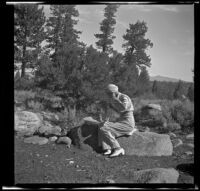 Mertie West sitting on a rock, Mono County, 1941