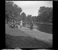 H. H. West stands beside the Boston Common Frog Pond, Boston, 1947