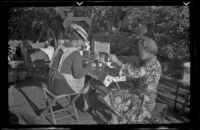 Agnes Whitaker and Mertie West eat at a table at Rock Creek, Mammoth Lakes vicinity, 1940