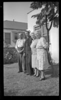 Romayne Shaw, Richard Shaw, Edith Shaw and Josie Shaw pose in the backyard of W. H. and Josie Shaw's home, Los Angeles, 1946