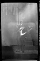 H. H. West poses in front of the entrance gate to Burial Hill, Plymouth, 1947