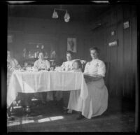 Mary West sits at her dining room table with her daughter, brother-in-law, cousin, and maid, Venice, about 1903