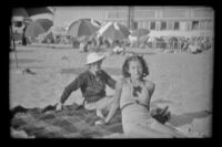 Mertie West and Margaret Deming pose on the beach, Hermosa Beach, 1937
