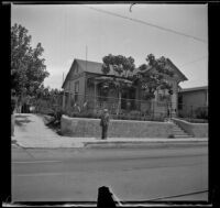 Wilson West stands in front of a house on Daly Street, Los Angeles, 1936