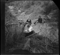 George M. West pans for gold while H. H. West and Frank Lemberger watch, Monrovia, 1898